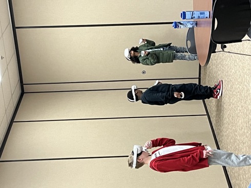 Three Kentucky students experiencing careers while wear VR headsets.